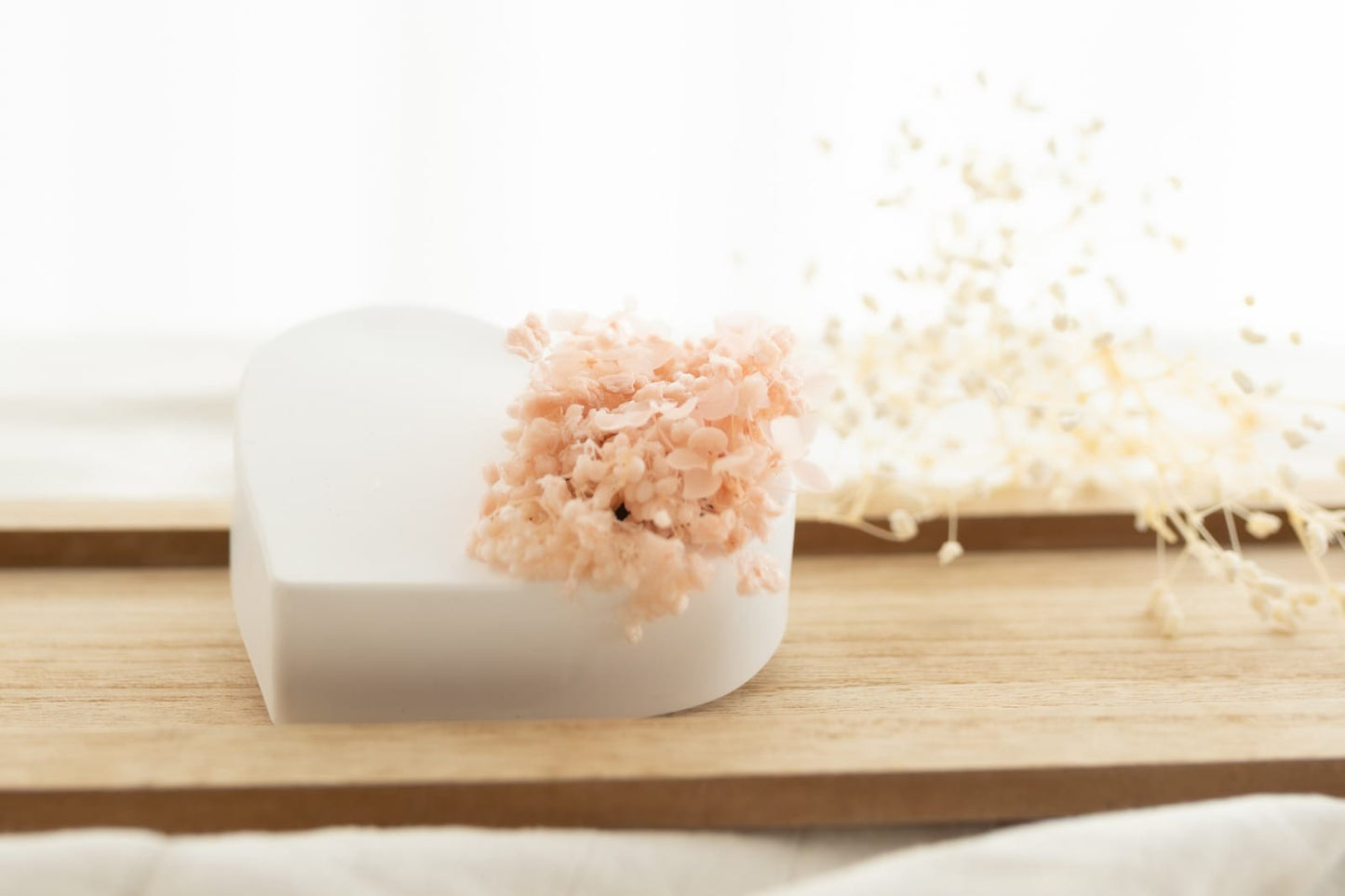 A plaster heart scented with preserved flowers.