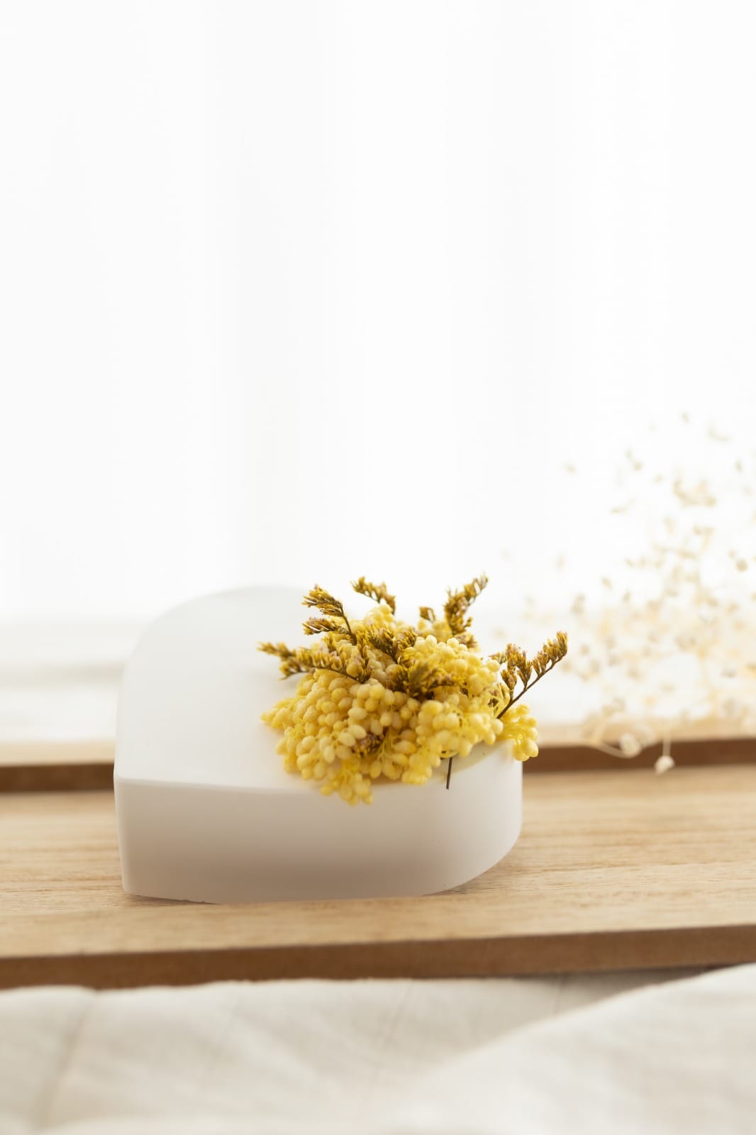 A plaster heart scented with preserved flowers.