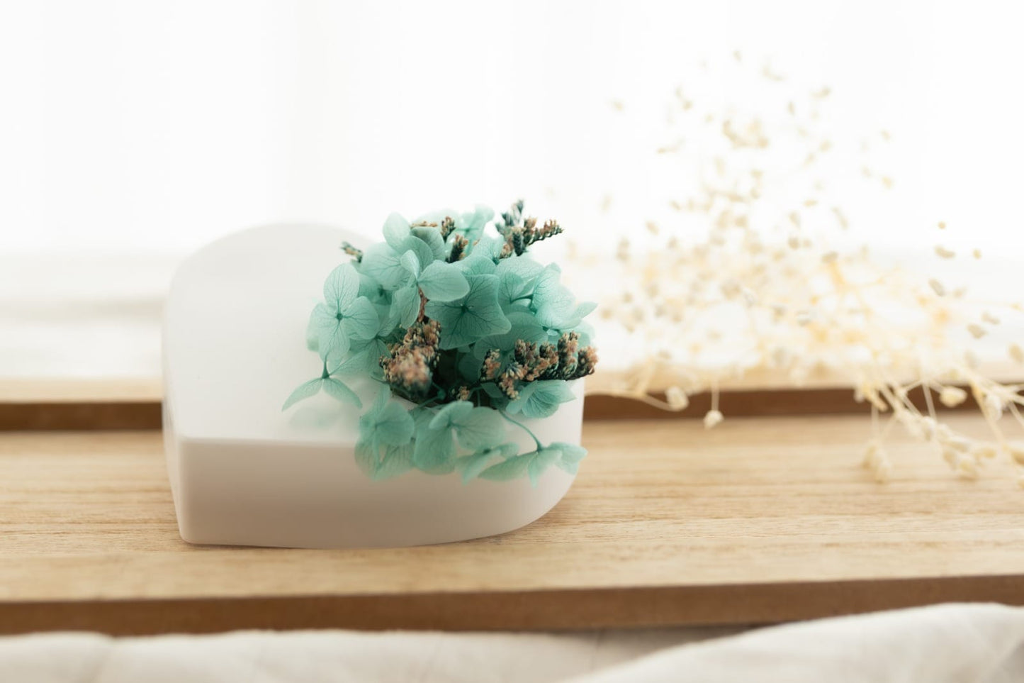 A plaster heart scented with preserved flowers.