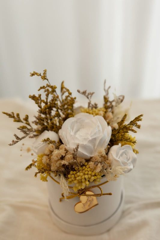 Box containing preserved flowers and scented plaster flowers.