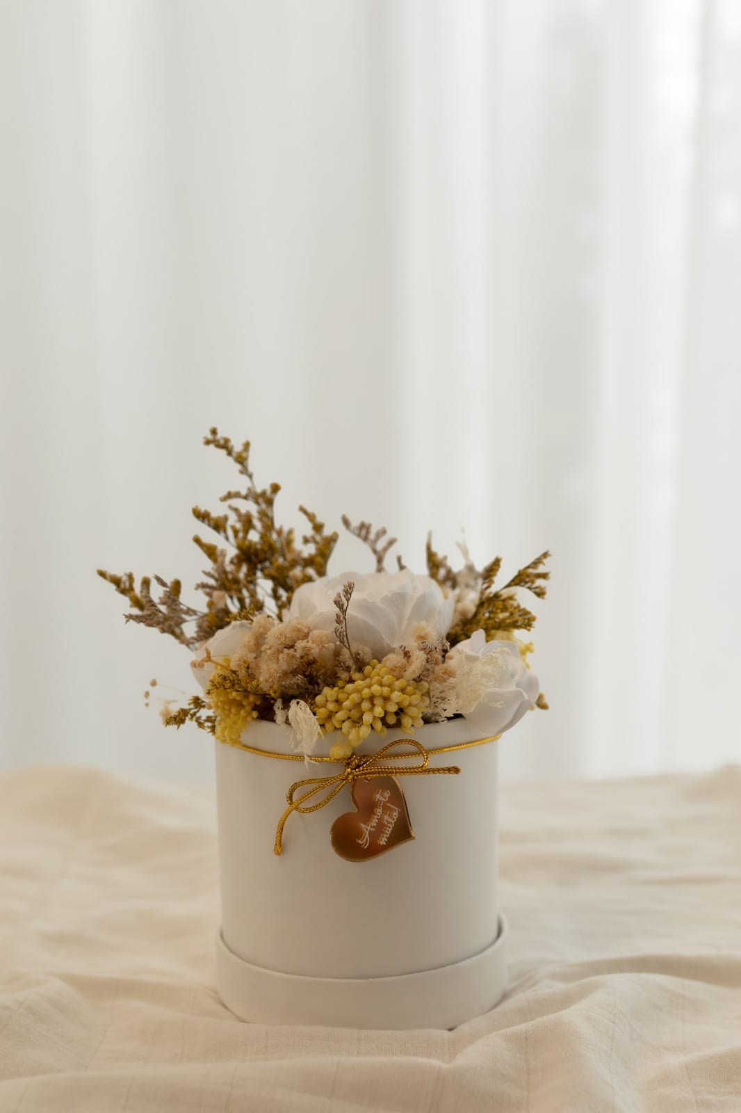 Box containing preserved flowers and scented plaster flowers.